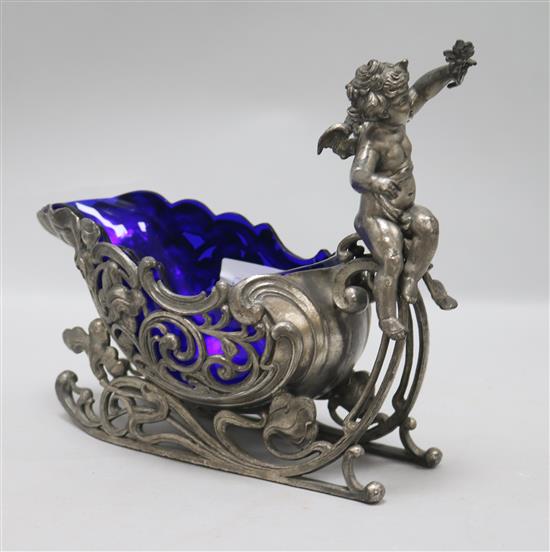 A putti sleigh centrepiece with glass liner